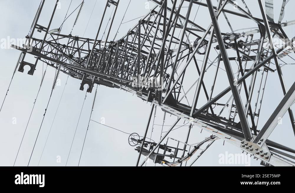 Huge Metal high-voltage tower with electric wires, the bottom view up ...