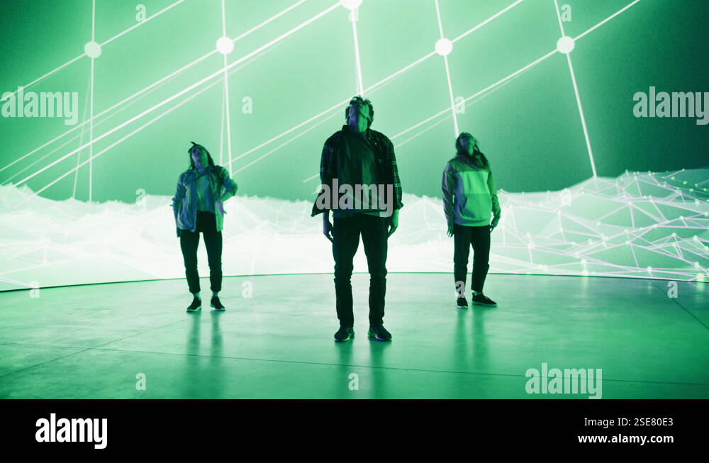 Three Dancers Performing in Front of Animated Digital Screen Stock ...