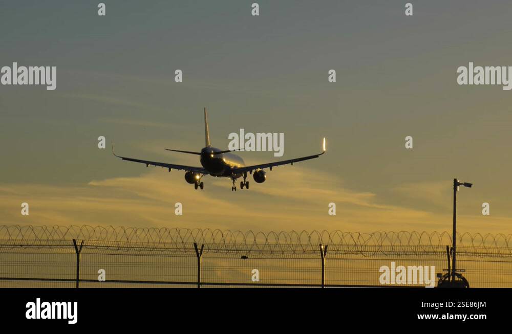 Silhouette of Airplane Landing at the Airport at Sunny Sunset. Slow ...