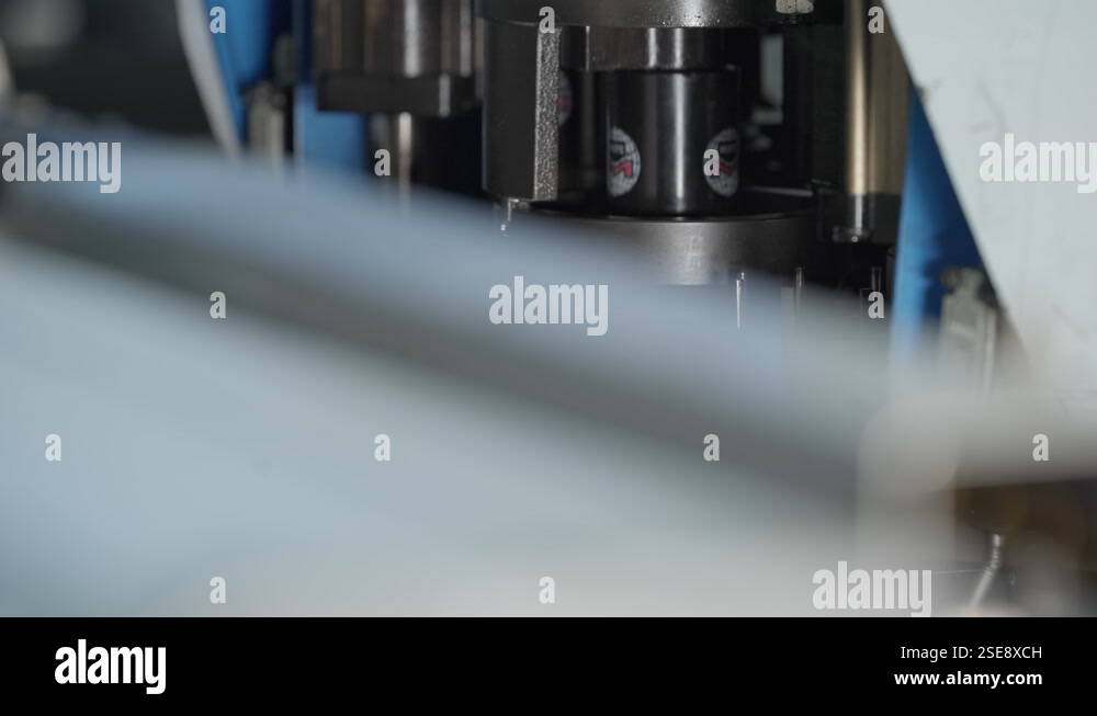 Factory. A Part of the Vertical Machine is Quickly Piercing the Metal ...