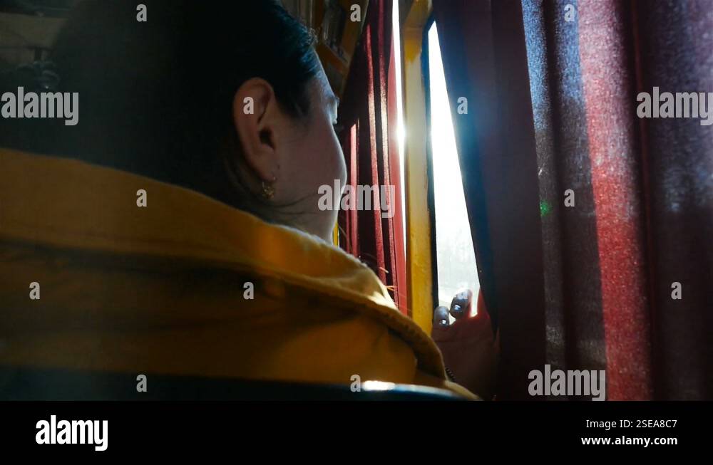 Girl rides in public transport. The ride on the bus. Looks out the ...