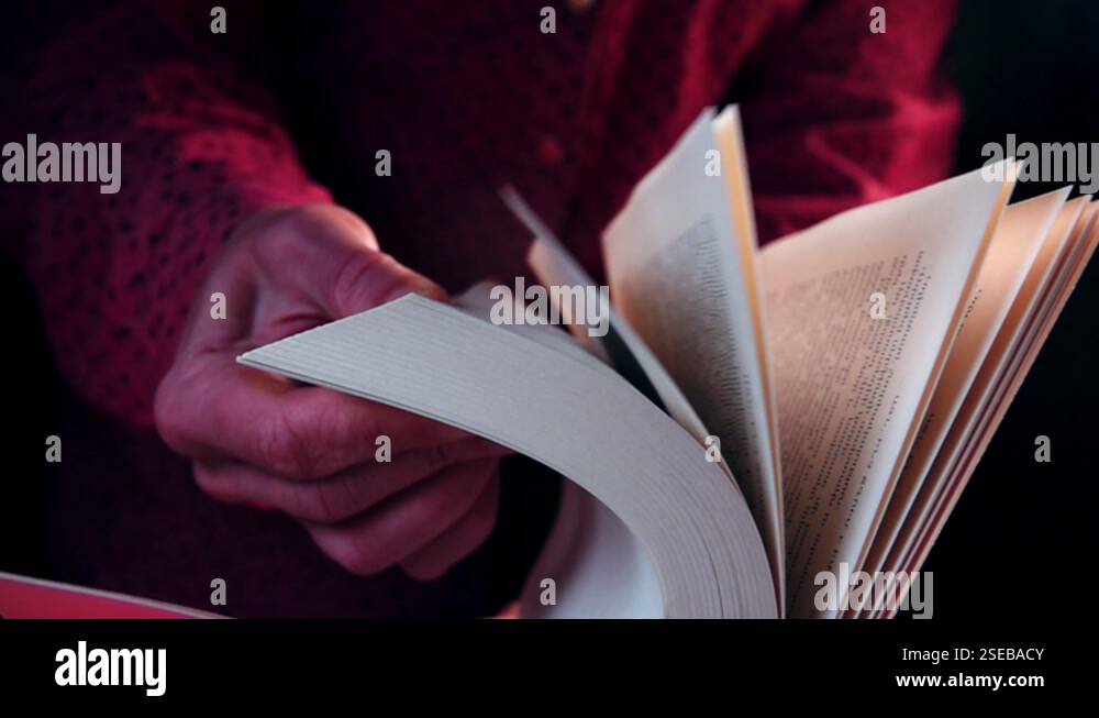 Turning pages of the book, close-up. Slow motion video of an old book's ...