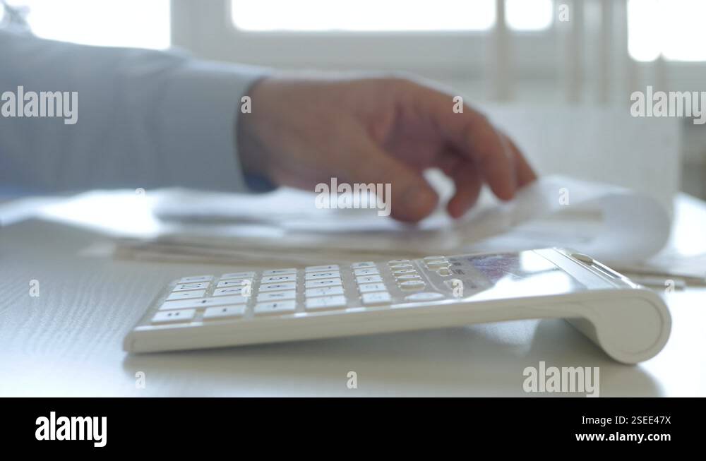Finance Adding Machine Man Working with Invoices, Makes Financial Calculations with Adding ...