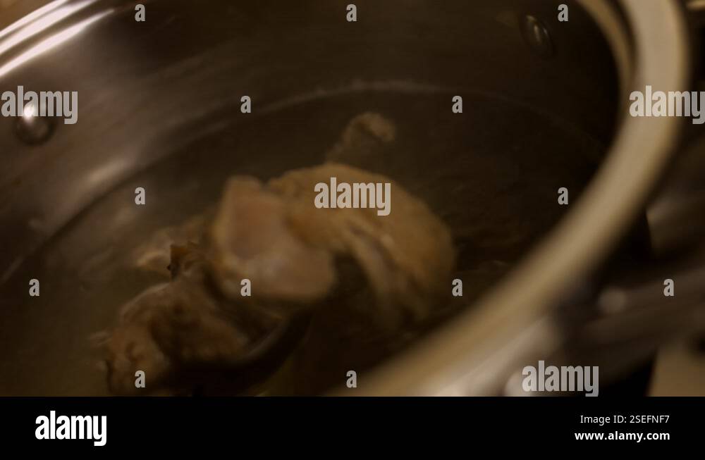 Pour beef meat into boiling water. 4k cinematography video recipe Stock ...
