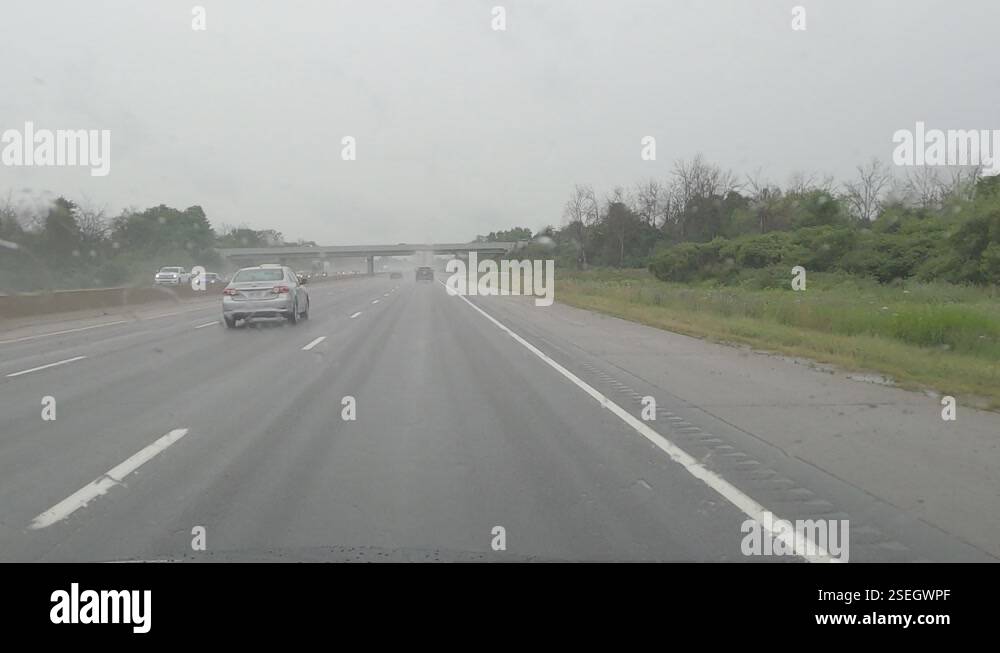 POV cars and trucks driving in heavy rain storm with poor visibility on ...
