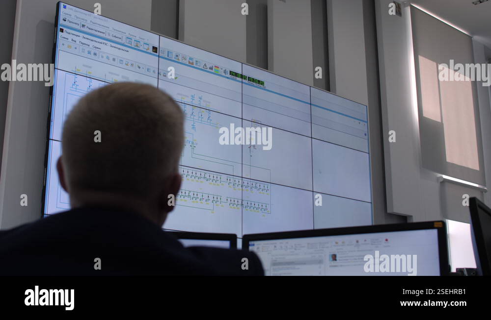 Engineer looks at monitor with equipment connection scheme Stock Video ...
