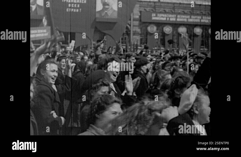 1940s: City. Joseph Stalin and dignitaries watch parade. People walk ...