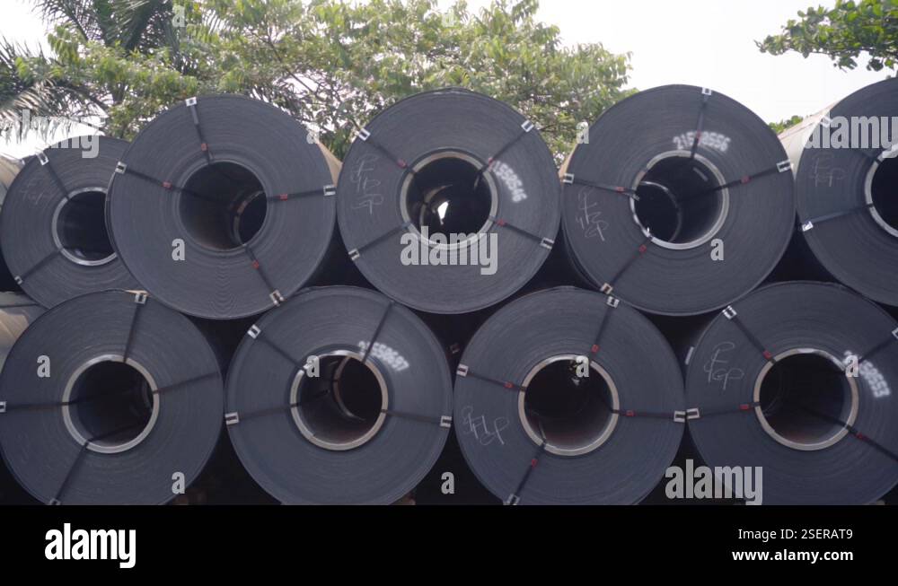 Large metal rolls, outdoors at the Goa Port, in sunny India - tracking ...