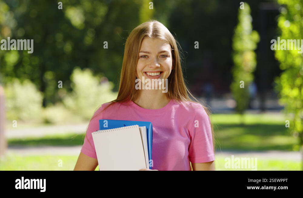 Students portrait with notebooks outside Stock Video Footage - Alamy