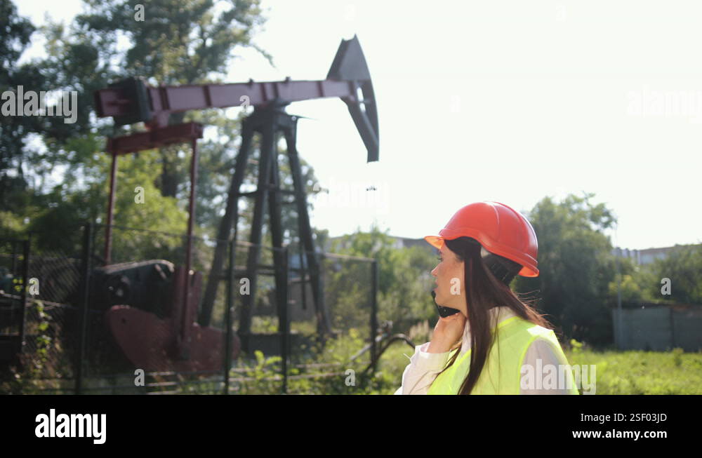 Concept reducing oil production. Falling prices. Woman with a phone oil ...