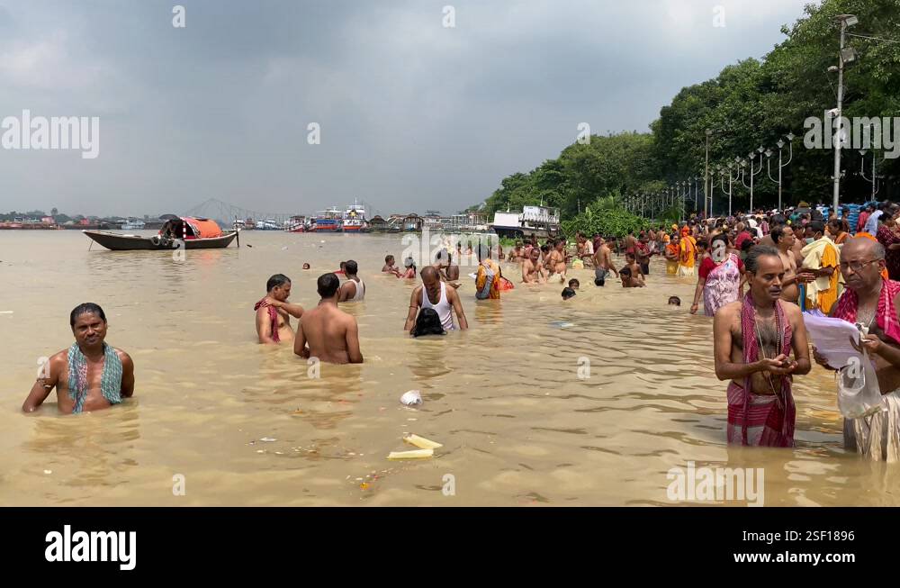 Close up video of people taking ritual bath in the river Ganga in early ...
