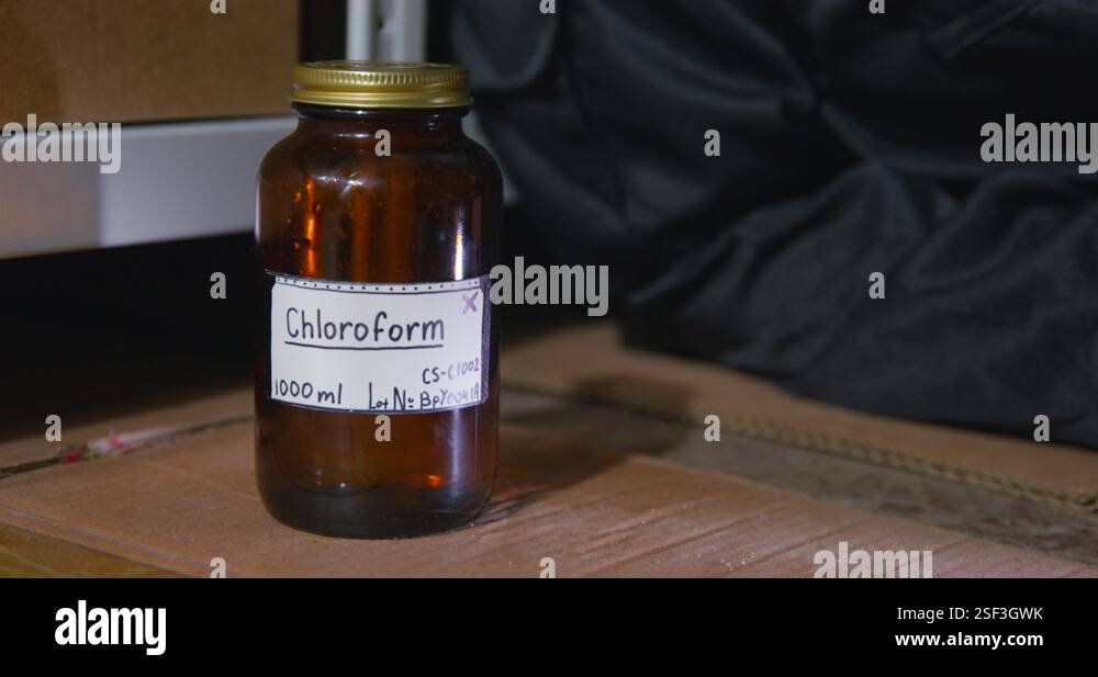 Chlorflorm Rag A rag falls on the surface next to a jar of chloroform, close up ...