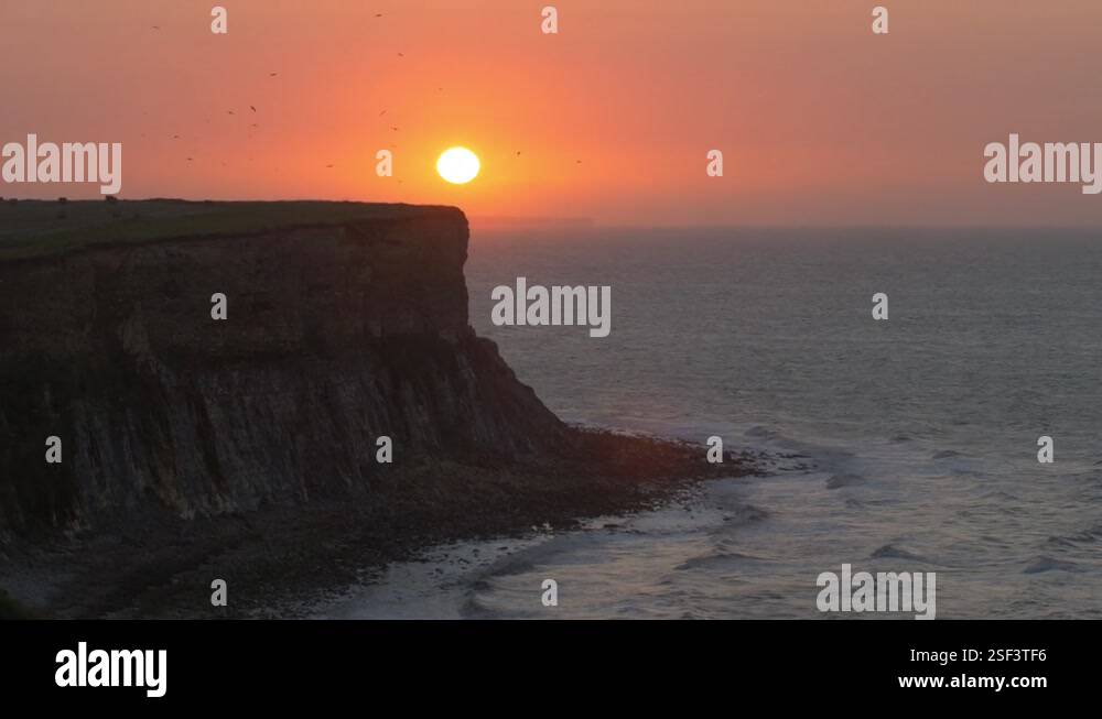 View of the sunset and steep cliffs of the Atlantic wall , Normandy ...