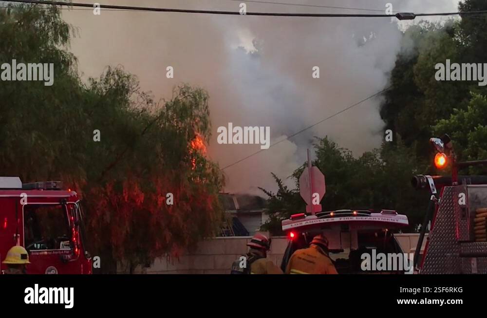 firefighters work to contain house fire Stock Video Footage - Alamy