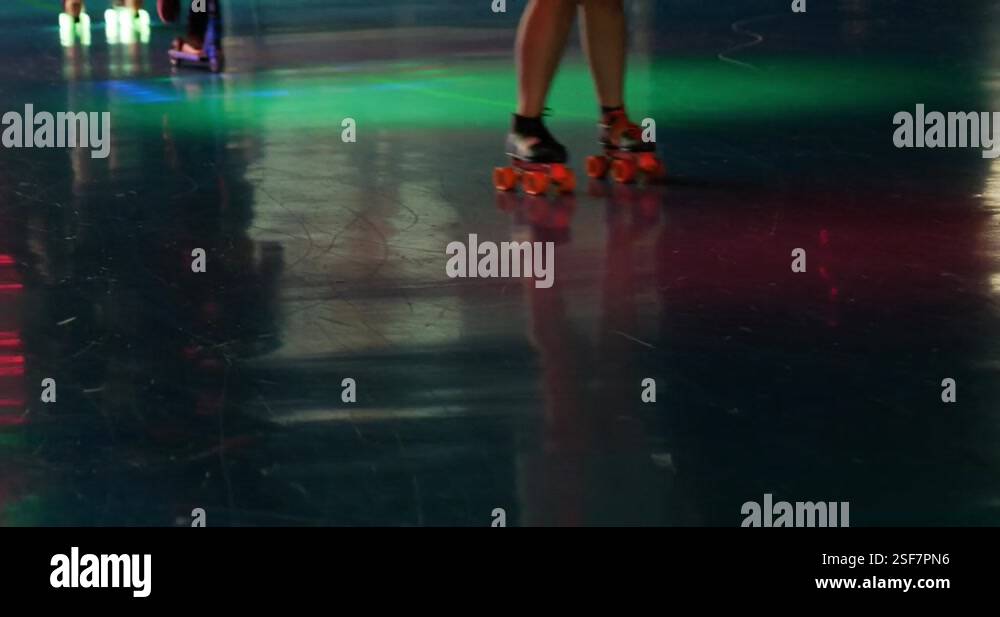 Busy roller skating rink with razor scooters rollerblades and ...