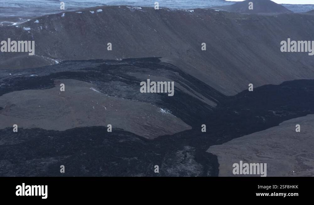 Black solid river of basalt rock through valley in highlands Iceland ...