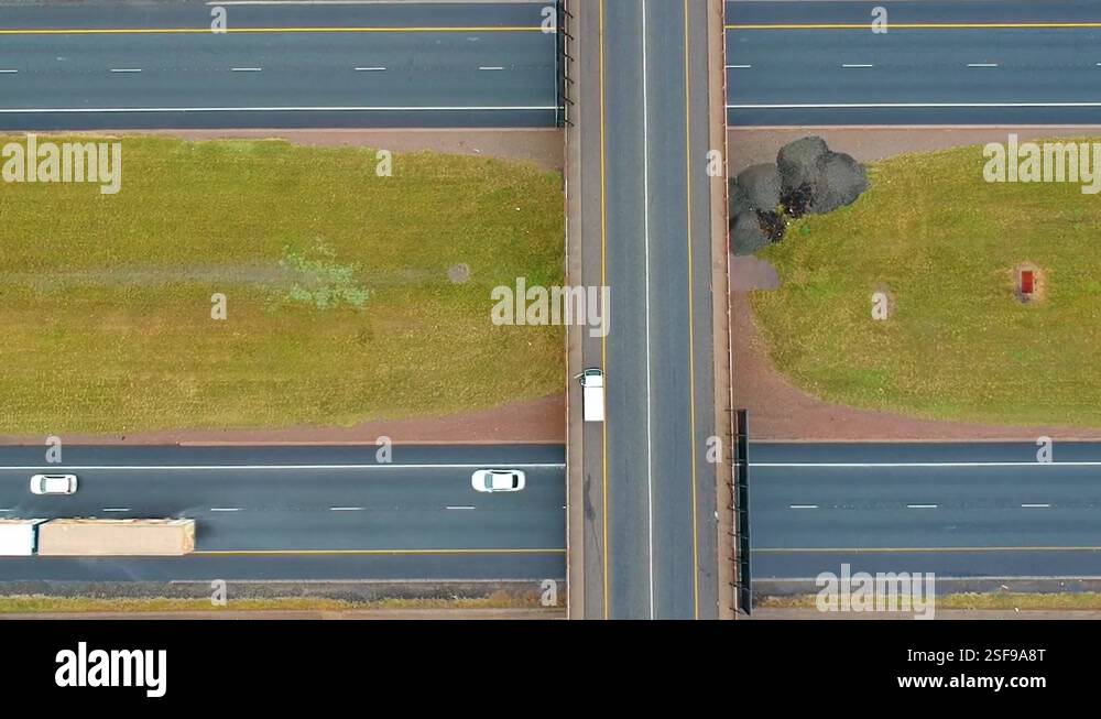 Bridge over a freeway, rising drone shot top down Stock Video Footage ...