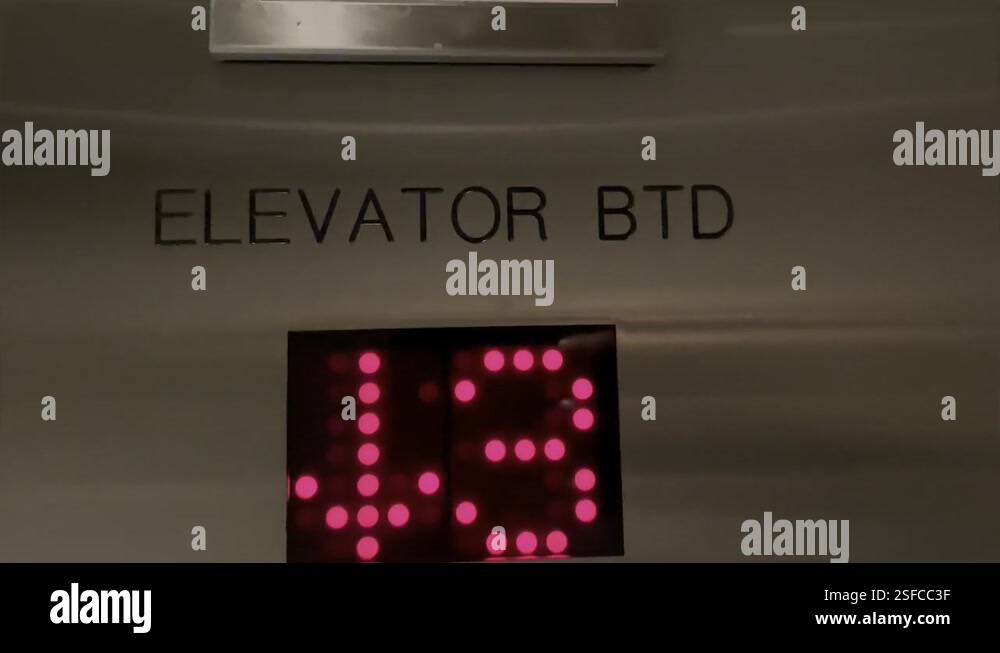 Shaky handheld video Illuminated elevator numbers going down Stock ...