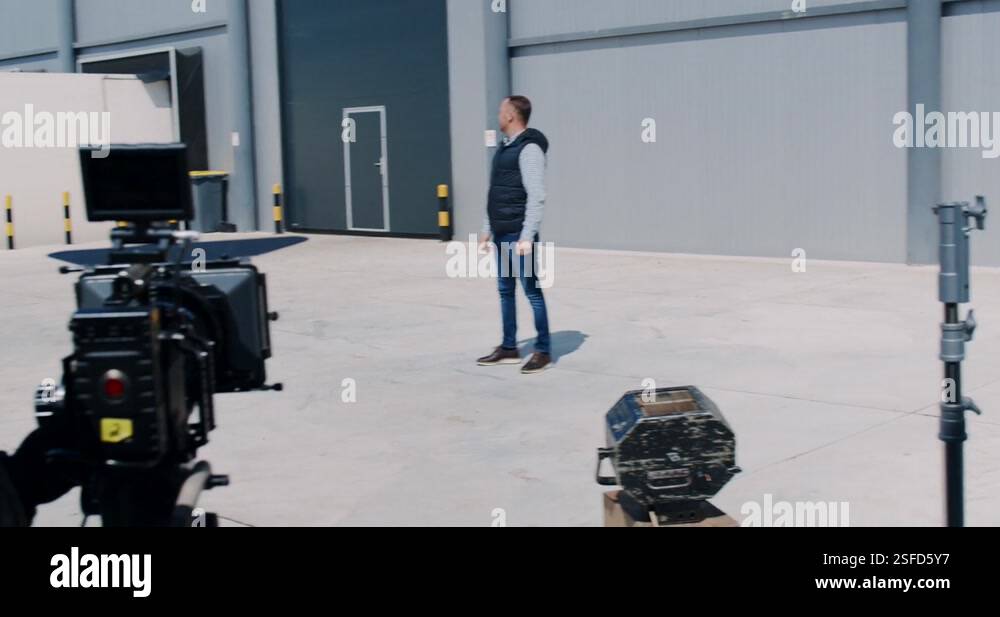 Behind the scene. Actor in front of the camera on the film set outdoor ...