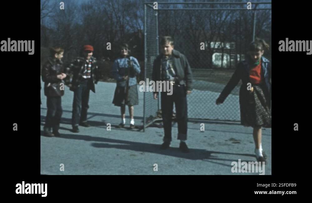 1950s Building Parking Lot Children Jump Cheer Girl Picks Up 1950s building parking lot children jump cheer girl picks up