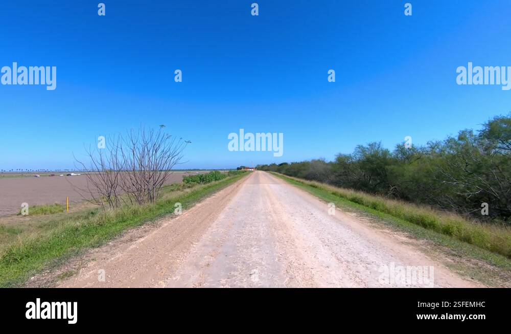Rural Rgv POV driving on a gravel road through rural Rio Grande Valley south of ...