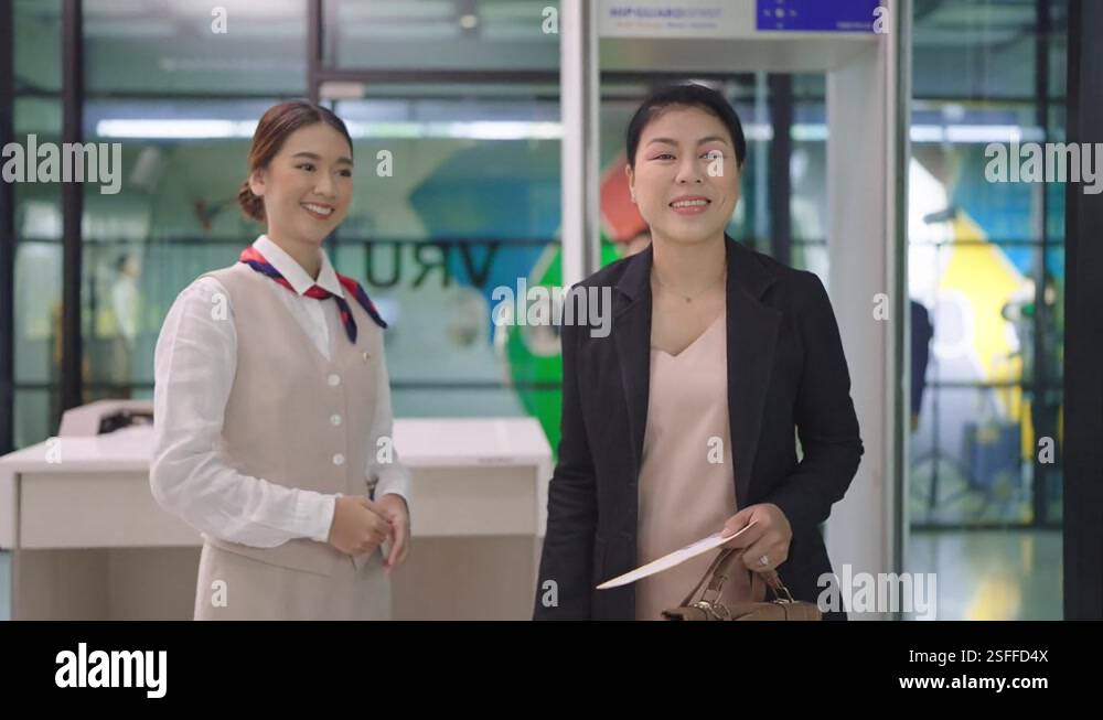 Security agent at airport check in gate with metal detector and scanner ...