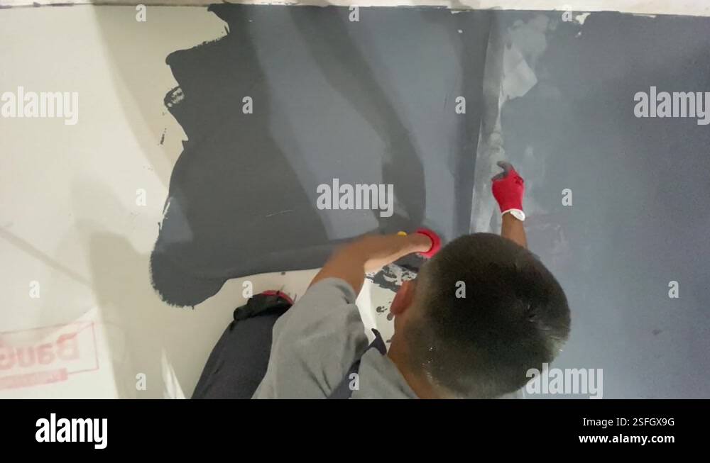 Applying a decorative microcement coating to the floor Stock Video ...