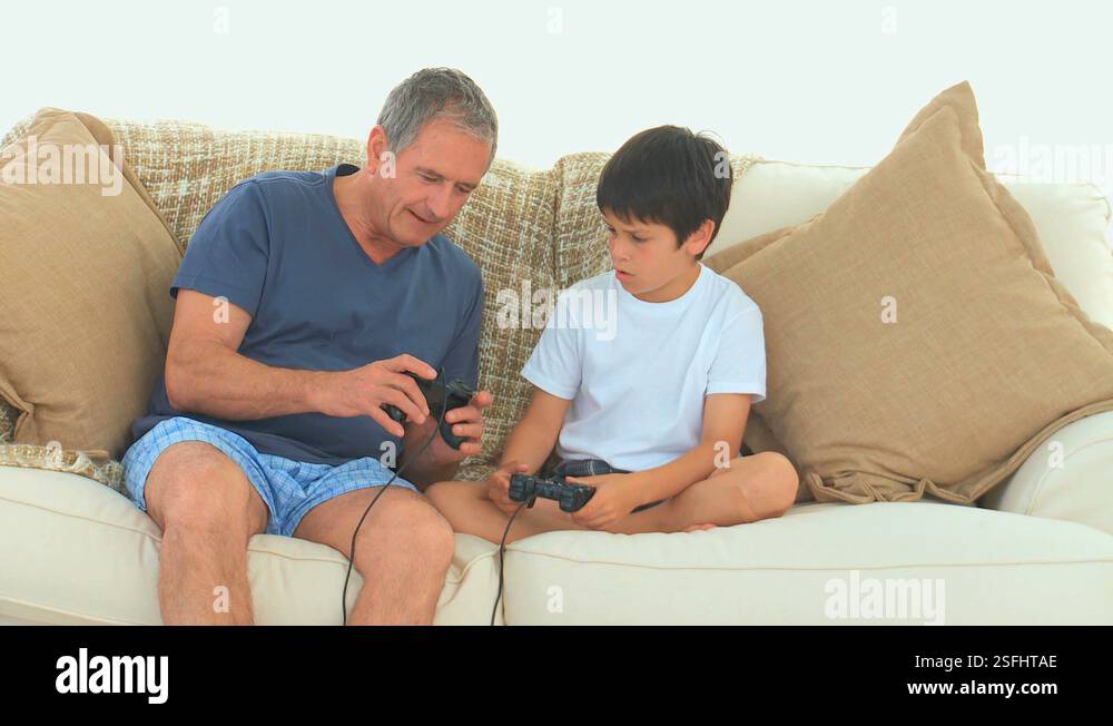 Boy teaching to his grandfather how to use a joystick Stock Video ...