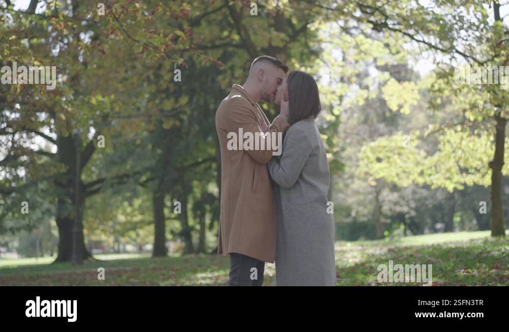 Slow motion - Young couple kissing and hugging in the park Stock Video ...