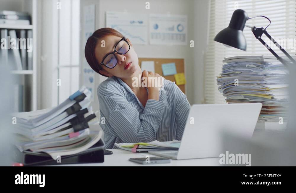 Tired Asian office employee massaging neck and shoulder muscles, office ...