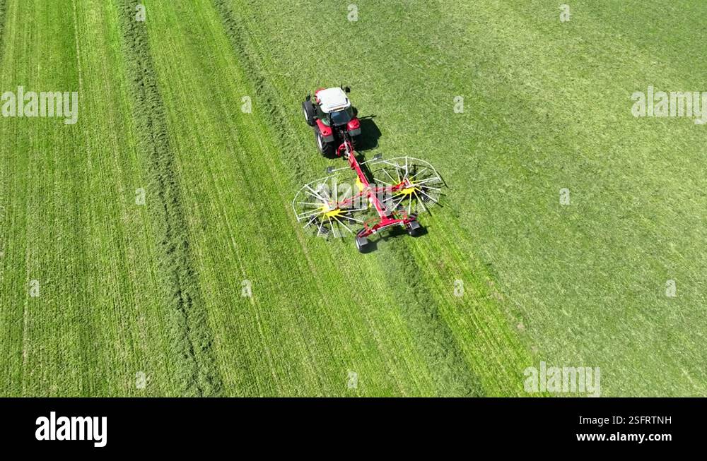 Tractor pulling a rotary rake Stock Video Footage - Alamy