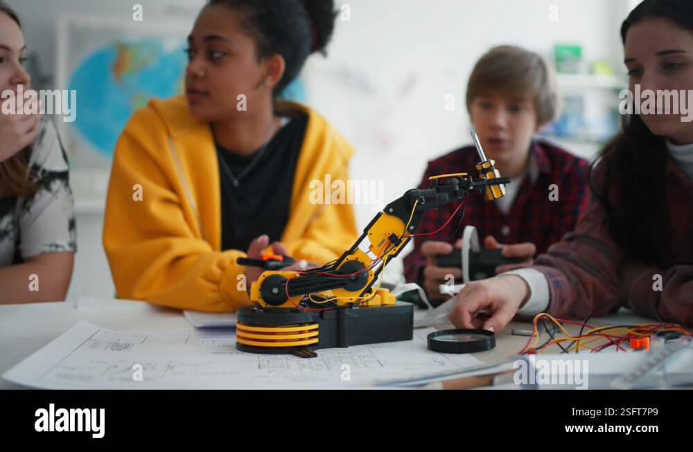 Group of students building and programming electric toys and robots at ...