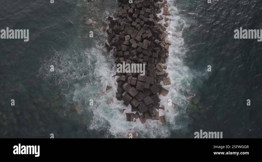 Spit With Rocks waves crashing over a spit of rocks in the sea. shot on a mavic pro in ...