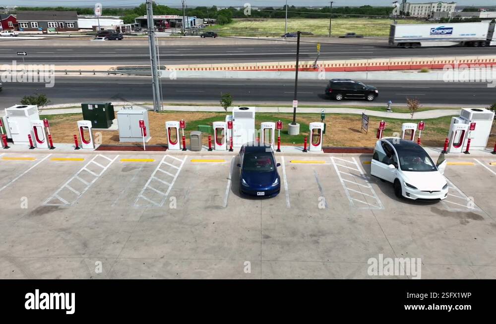 Tesla chargers at supercharging station. Big gas station and rest stop ...