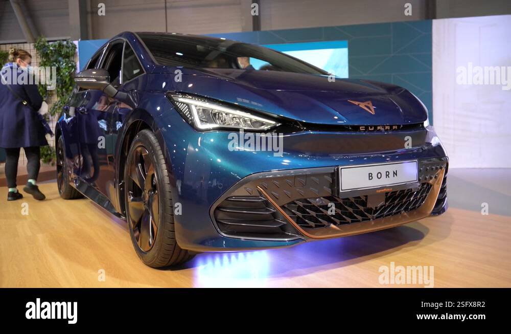 Navy blue Cupra Born at a car exhibition - low front view - people sit ...