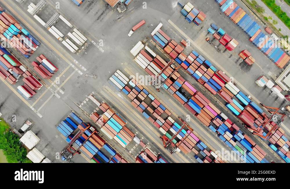 Stacked red and blue containers at terminal, global logistics; overhead ...