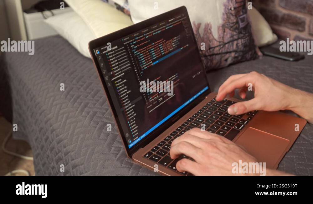 hands typing on a keyboard creating a web-based computer program in an ...