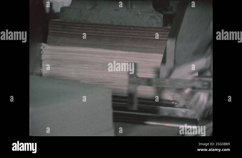 1970s: Machine cuts stacks of paper. Man cuts pasta. Machine punches ...