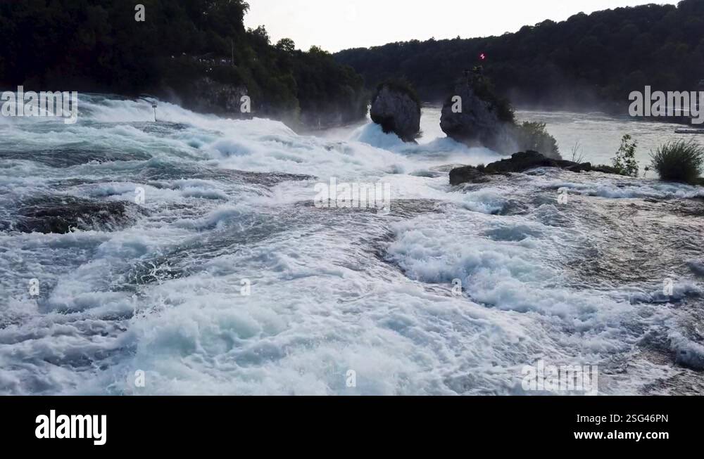 Fast flowing wide river with white water, top of the waterfall ...