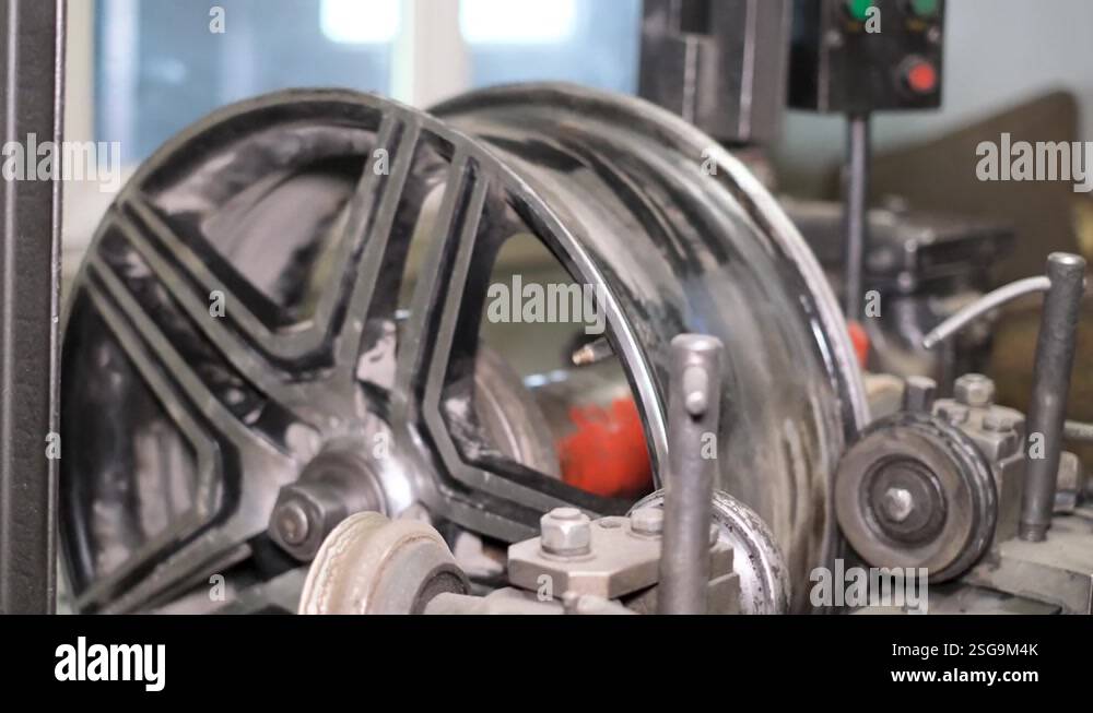 Auto mechanic aligns car rims. Tire fitting Tire machine for rolling ...