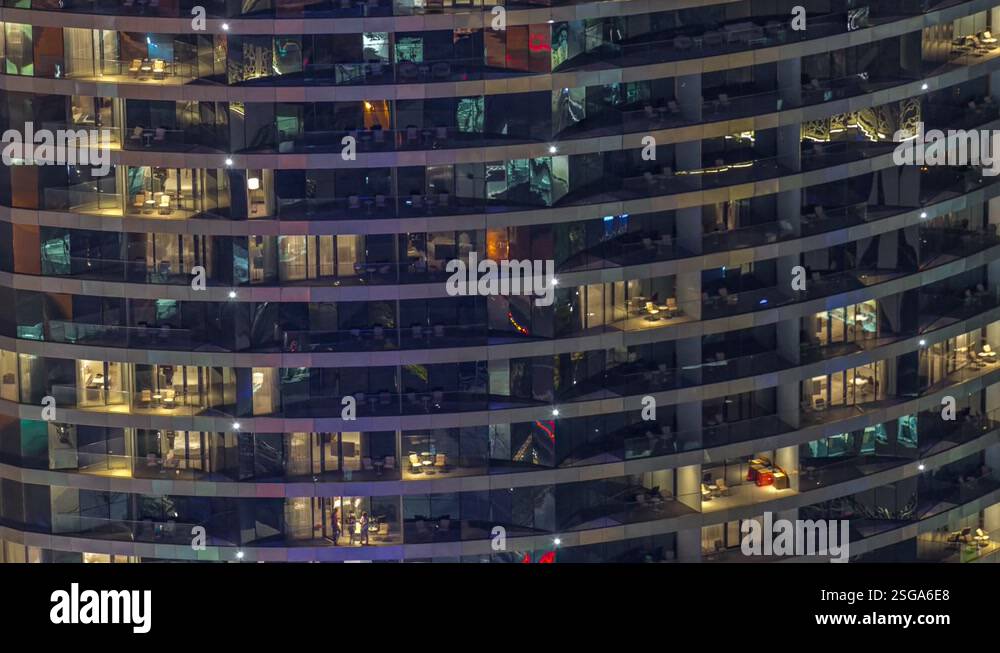 Outside view of windows in apartments of a high class building at night ...