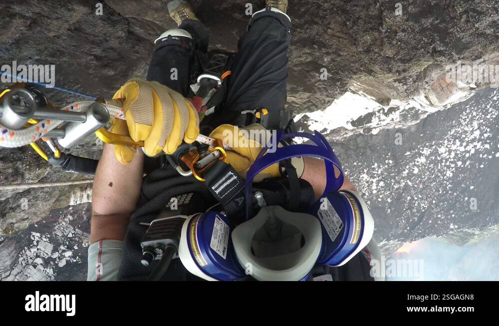 Man Rappelling on Ropes into an Active Volcano. POV Action Cam Shot ...