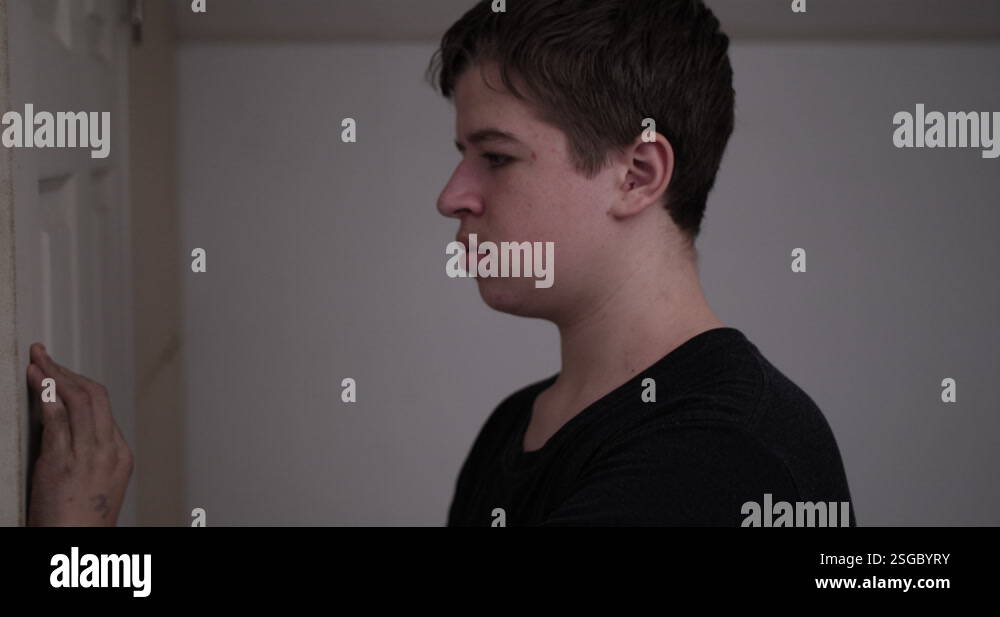 Picture of A young high school aged teen boy looking angry, troubled, depressed ...