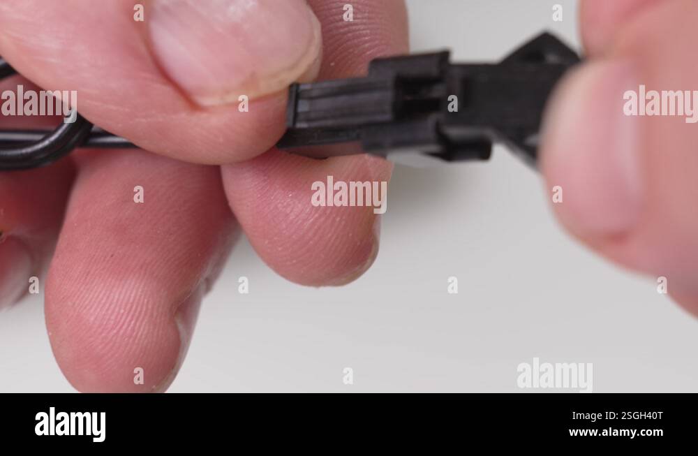 Men's hands insert a wire into the connector of the charger Stock Video ...