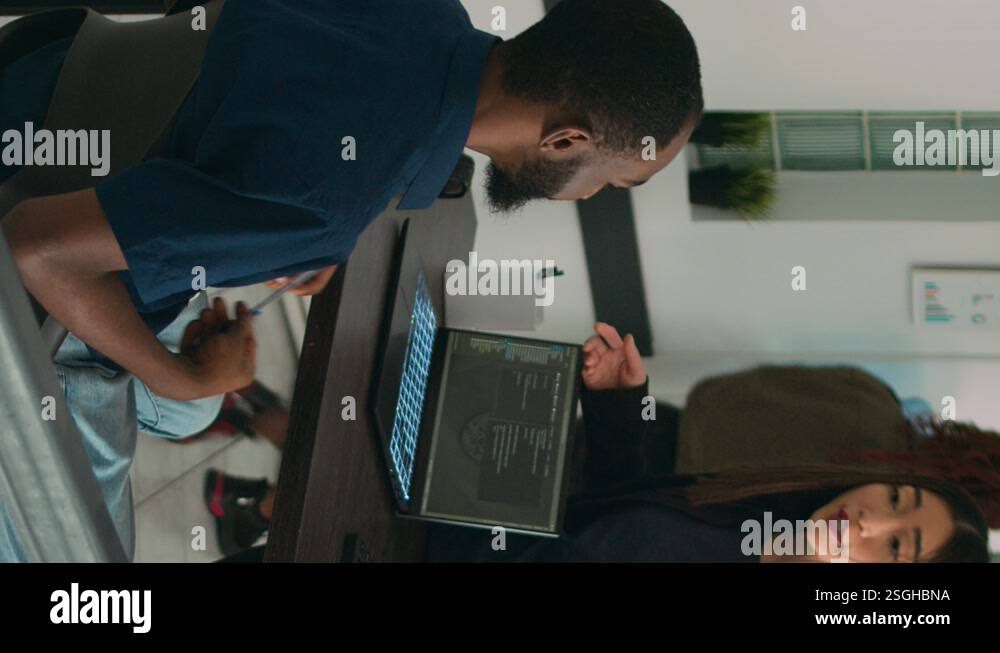 Vertical video: Diverse coders talking about source code on terminal ...