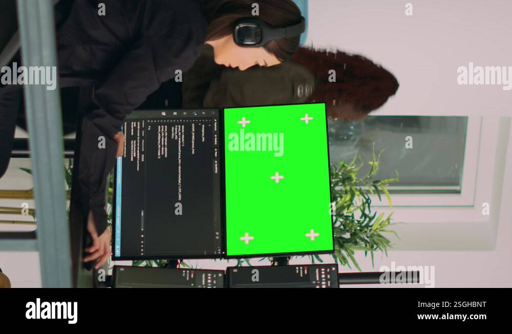 Vertical video: Asian system engineer programming app code on monitors ...