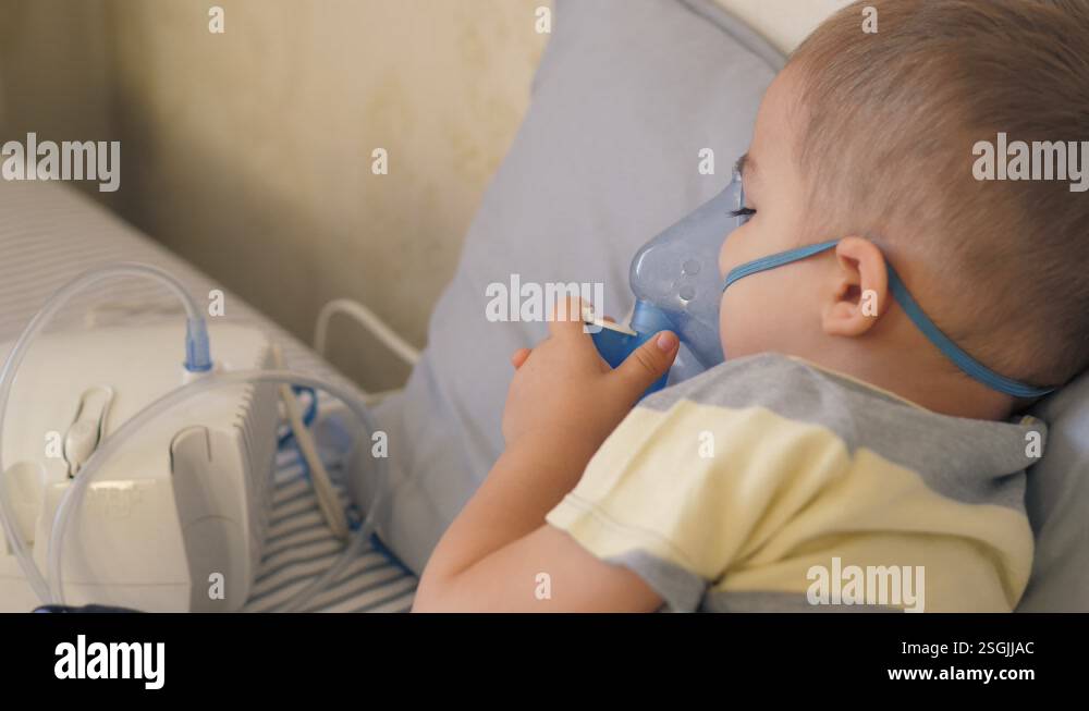 Little 2 years old boy does therapeutic inhalation using a nebulizer ...