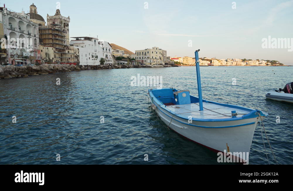 Blue and white fishing boat rocks at pier on Ischia at dawn Stock Video ...