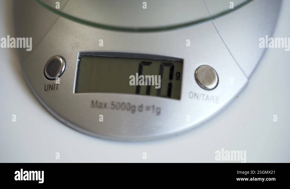 Numbers on digital scale display changing while weighing in grams Stock ...