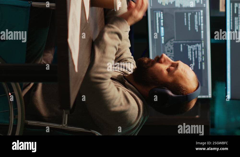 Vertical video: IT web developer writing source code in office Stock ...